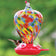 Art Glass Hummingbird Feeder Balloon with three perches, colorful glass reservoir, and decorative copper wire for hanging. Features three flower feeding stations.