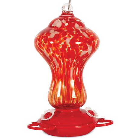 Art Glass Color Explosion Hummingbird Feeder with three perches, see-through glass reservoir, red plastic base, and white flower feeding ports. Includes cable hanger.