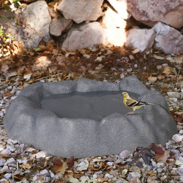 Ground Birdbath, Gray, on a rock-like base, offering multiple bathing levels and stable footing, made of durable plastic resin for year-round use.