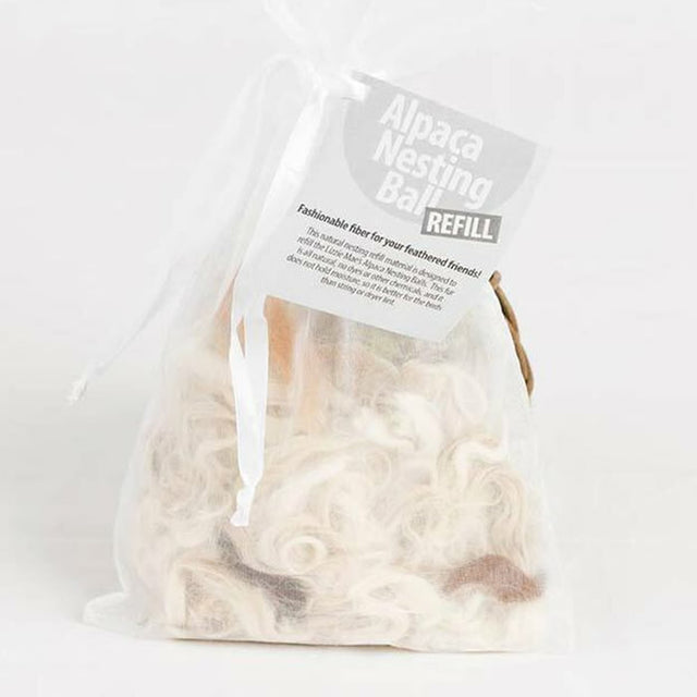 Alpaca Nester Refill: A close-up of a plastic bag containing soft white and brown alpaca wool, ideal for bird nest insulation.