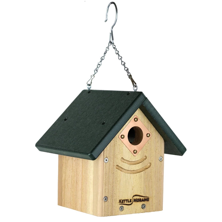 Weather-resistant birdhouse featuring natural cedar construction and a durable green recycled-plastic roof.
