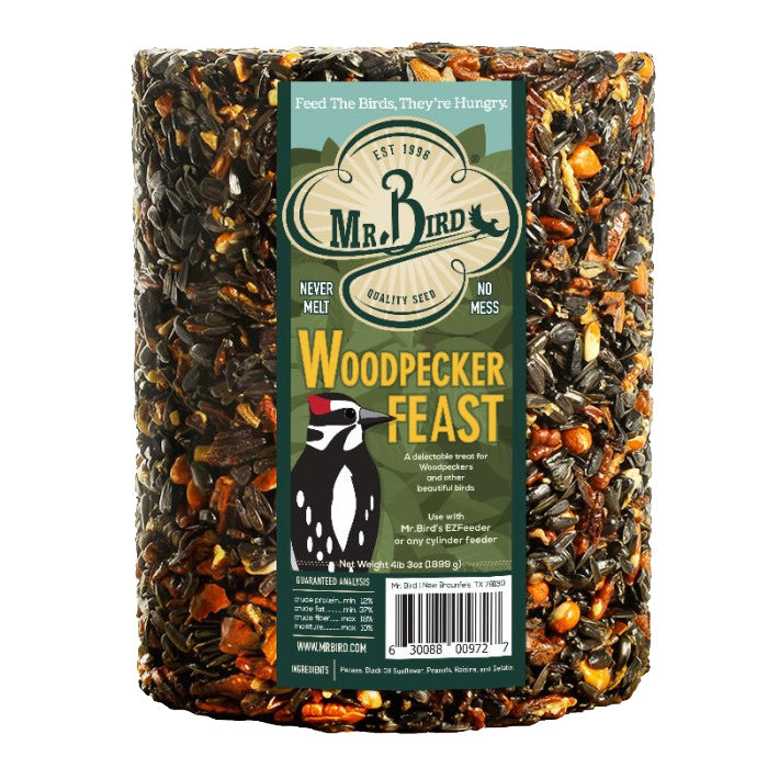 Woodpecker Feast Cylinder Large featuring a dense mix of sunflower seeds, peanuts, pecans, and raisins, with a label depicting a cartoon penguin and a bird.