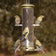 Aspects Antique Brass 6 Port Finch Tube Feeder with finches feeding on multiple perches, showcasing its durable metal build and clearview plastic tube.