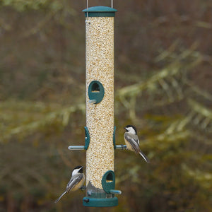 Aspects Large Spruce Tube Feeder with six perching areas, filled with bird seed, showing birds actively feeding.