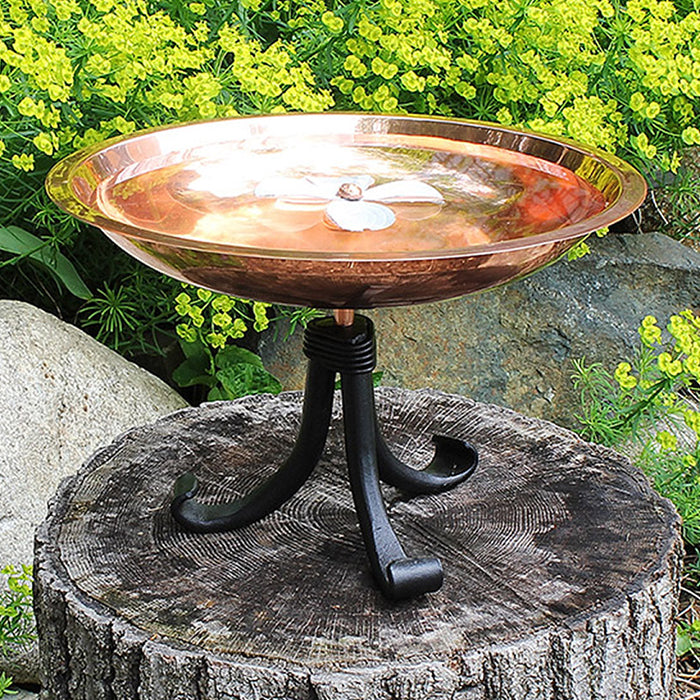 Dogwood Bird Bath with Tripod Stand featuring a dogwood blossom center, sturdy wrought iron stand, and copper-plated basin, ideal for birds and pollinators.