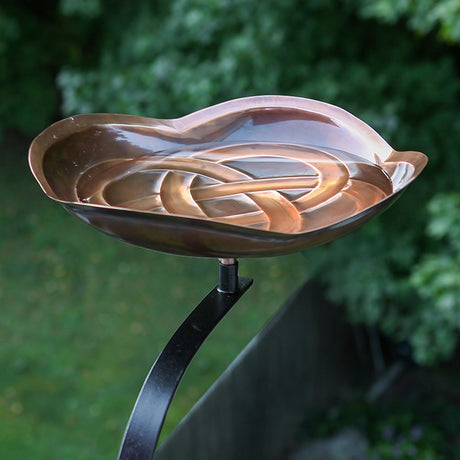 Dara Knot Bird Bath with Rail Mount Bracket, heart-shaped, copper-plated brass basin, intricate Celtic design, securely mounts to deck railing for close bird watching.