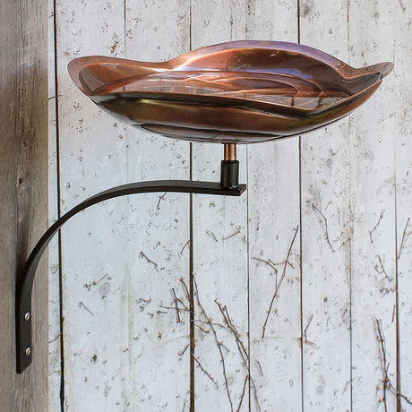 Dara Knot Bird Bath with Wall Mount Bracket, featuring an intricately designed copper-plated basin and a weather-resistant wrought iron bracket, perfect for bird watching.