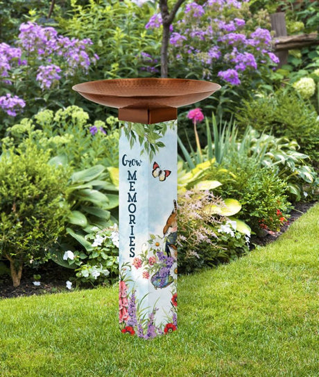 Sweet Home Bird Bath in a garden setting with illustrated sides, copper-plated stainless steel topper, and a durable PVC post standing 31 inches tall.