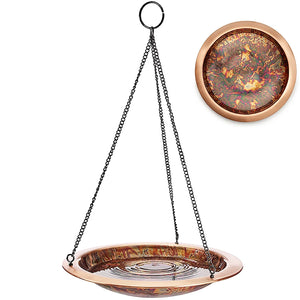 Copper-colored hanging bird bath with chain on a white background