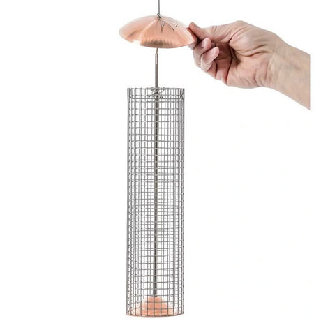 Hand holding a Birds Choice Copper Shelled Peanut Mesh Feeder with stainless steel wire mesh and copper top and bottom.