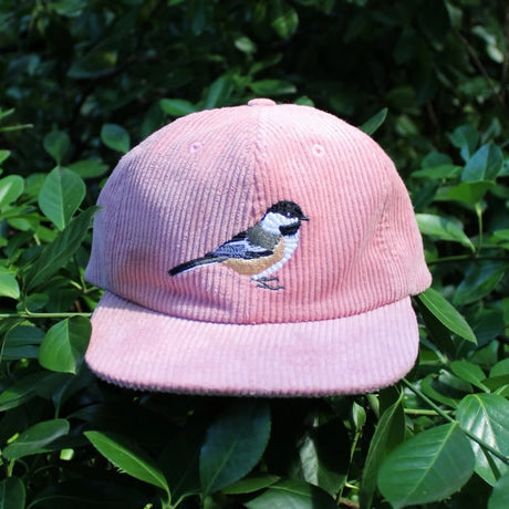 Bird Collective Chickadee Corduroy Hat featuring an embroidered chickadee logo, flat bill, and adjustable strap, perfect for birdwatching or outdoor adventures.