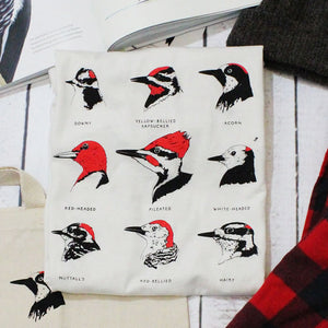 Bird Collective Woodpeckers T-Shirt featuring nine woodpecker profiles, emphasizing their unique shapes and patterns. Made from soft, breathable cotton, suitable for bird enthusiasts.