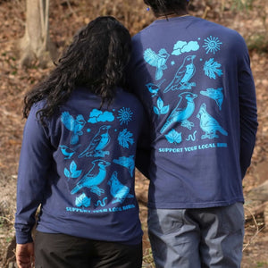 Bird Collective Bird Friends Long Sleeve T-Shirt featuring bird designs, worn by two people standing in the woods.