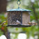 Triple Option Bird Feeder with three seed compartments, hosting sunflower and mixed seeds, attracting goldfinches and chickadees, showcasing six perches for simultaneous feeding.