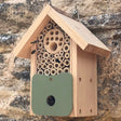 Bee Barn Bee Nester: Wooden insect house with various compartments, designed for solitary bees and pollinators, featuring a recycled plastic door for easy access.