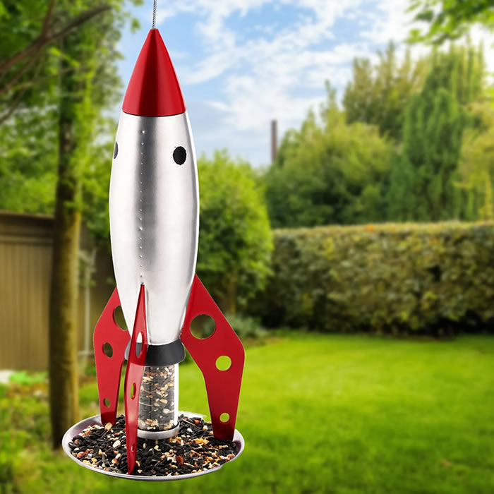 Rocketship Bird Feeder: A bird feeder shaped like a rocket, made of metal, designed for easy hanging and bird feeding in outdoor spaces.