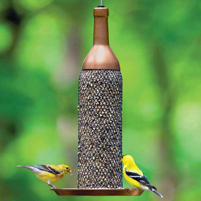 Mesh Wine Bottle Bird Feeder with copper finish, filled with seeds, featuring a sturdy metal mesh tube for multiple birds to dine, and a raised lip tray.