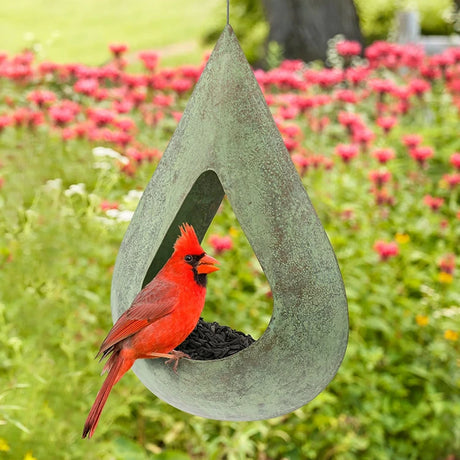 Rain Drop Fly-Thru Verde Copper Bird Feeder with black oil sunflower seeds, features copper construction, matte black mesh, and a teardrop design for easy bird access.