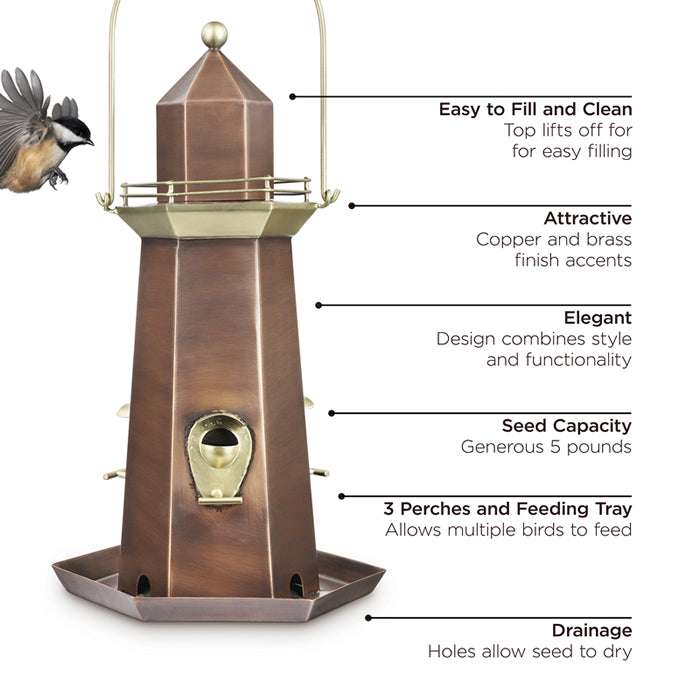 Lighthouse Bird Feeder with brass and hand-rubbed copper finishes, featuring a bird flying nearby. Designed for easy filling, cleaning, and attracting various songbirds.