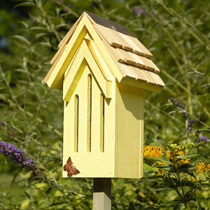 Mademoiselle Butterfly House with a copper butterfly on top, hand-shingled roof, and mounting stake, designed to attract butterflies. Measures 5 × 6 × 12 inches.