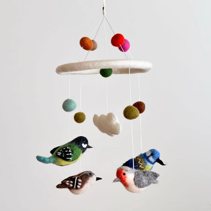 Felt Bird Mobile featuring handcrafted felt birds and balls, perfect for adding a whimsical touch to any room's decor.