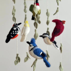 Felt Bird Wings Mobile featuring handcrafted wool-felt birds on a wooden frame, creating a charming, nature-inspired decor piece for nurseries or living spaces.