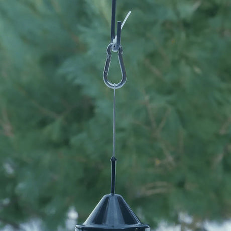 Brome BirdsUP Stainless Steel Snap Hook securely suspending a bird feeder from a wire, ensuring stability against wind and wildlife disruptions in an outdoor setting.