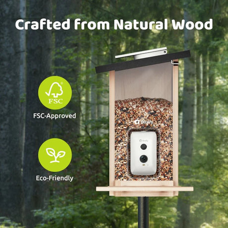Birdfy Feeder Ebony - Wooden Smart Bird Feeder with built-in camera, filled with birdseed, crafted from eco-friendly FSC-approved wood, mounted on a post in a forest.