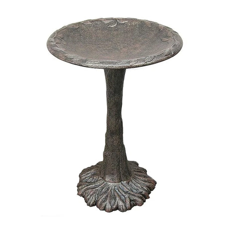 Decorative metal bird bath on a white background