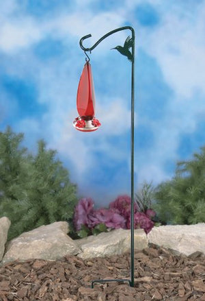 More Birds 42 Hummingbird Hook with decorative silhouette, holding a feeder, standing on a pole in a yard with flowers.