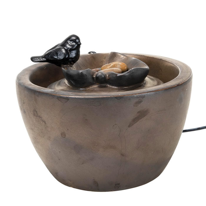 Sparrow On Leaf Fountain: A bird perched on a leaf in a ceramic tabletop fountain, with water bubbling over pebbles, creating a tranquil indoor atmosphere.