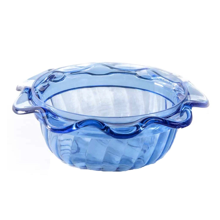 Blue glass pie dish with scalloped edge on a white background