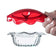 Clear glass dish with a red lid held by a hand on a white background