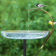 Universal Dripper showcased with chickadee and goldfinch perched on a copper tube, drips water into a glass basin, enhancing your birdbath's appeal.