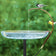 Universal Dripper showcased with chickadee and goldfinch perched on a copper tube, drips water into a glass basin, enhancing your birdbath's appeal.