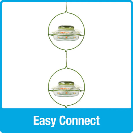 Nature's Way Decorative Top-Fill Glass Hummingbird Feeder, Gardenia Bouquet, featuring a clear glass dish, green glass lid, and three flexible flower ports for easy filling and cleaning.