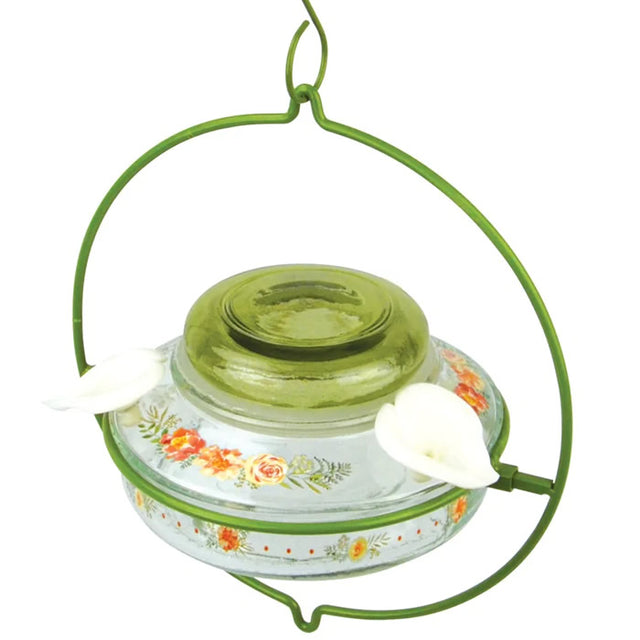 Nature's Way Decorative Top-Fill Glass Hummingbird Feeder, Gardenia Bouquet, features a clear glass dish, green lid, and lifelike flower ports for easy filling and cleaning.