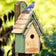 Duncraft Bluebird Manor House, Sage: Wooden birdhouse with a shingled roof, bluebird perched on top, entry hole in front, and DUNCRAFT logo visible.