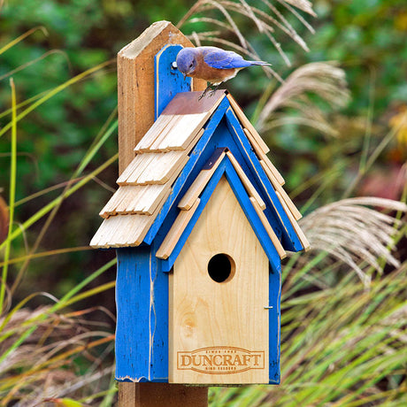 Duncraft Bluebird Manor House with bird perched on roof, featuring a shingled roof, copper peak, and cypress wood construction for bluebird nesting.