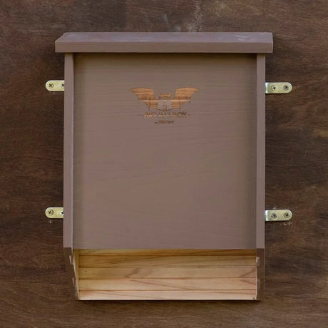 Two-Chamber Bat House, Brown, mounted on a wall, features two chambers, grooved interior, and ventilation, made from cedar for durable outdoor use.