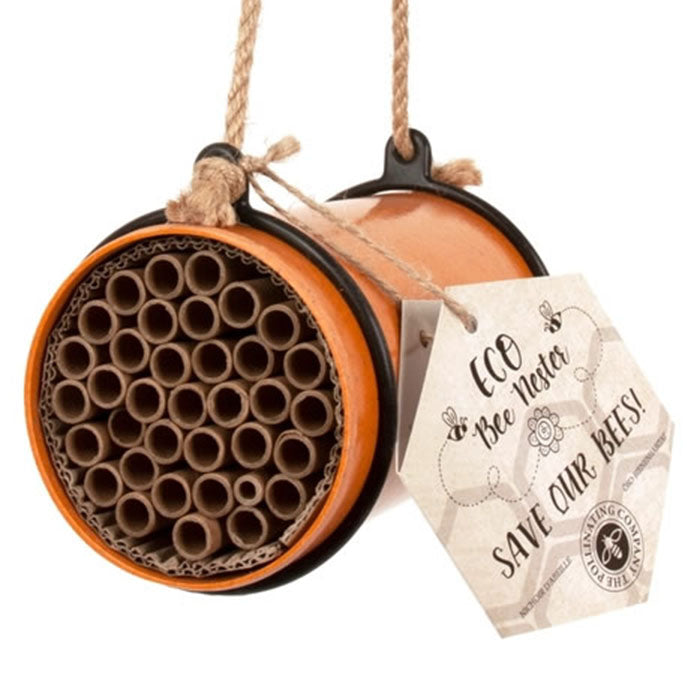 Eco Bee Nester in a container, designed for solitary bees, featuring natural plant fibers and tube openings for laying eggs.