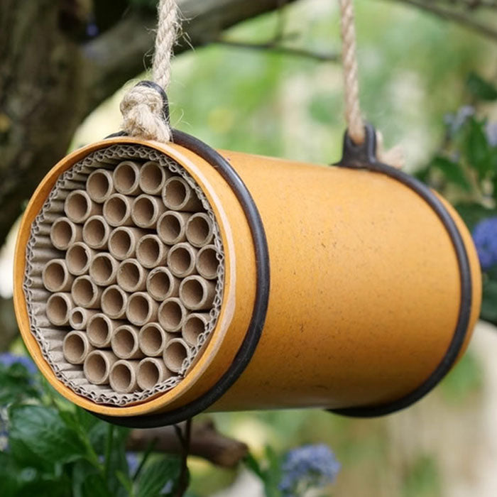 Eco Bee Nester made from natural plant fibers, featuring multiple tubes for solitary bees to lay eggs, designed to attract and care for garden pollinators.