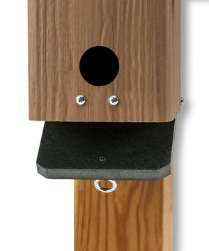 Duncraft Songbird House and Roosting Box featuring a wooden structure with entry holes and clear plastic flooring for easy cleanout.