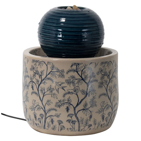 Georgie Chinoiserie Fountain: A tabletop water fountain featuring a blue and white ceramic base with a ribbed orb on top where water bubbles and trickles down.