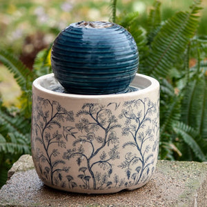 Georgie Chinoiserie Fountain: A tabletop ceramic fountain featuring a blue patterned base and a ribbed orb on top where water bubbles and trickles down.