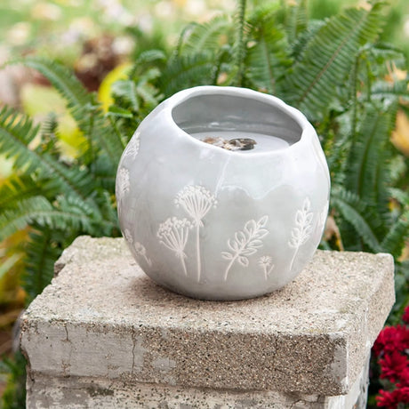 Wildflower Fountain with a round ceramic vase, botanical patterns, and bubbling water at the top. Features pebbles and a water pump for a tranquil atmosphere.