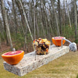 Fruitful Oriole Orange & Jelly Feeder made from reclaimed granite with metal dowels for orange halves and a removable glass dish for bird treats.