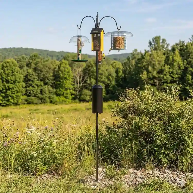 Squirrel-Proof Super Tall Quad Hanger featuring a three-arm pole with squirrel baffle, set in a grassy outdoor area, holds multiple bird feeders.