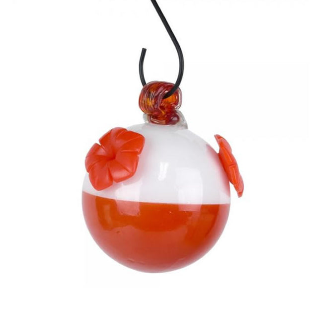 Bobber Glass Hummingbird Feeder: Close-up of a round glass feeder with three red flower ports designed to attract and nourish hummingbirds.