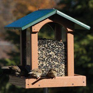 Going Green Tall Hopper Feeder with birds perched and feeding on all sides, showcasing its large capacity and durable build.